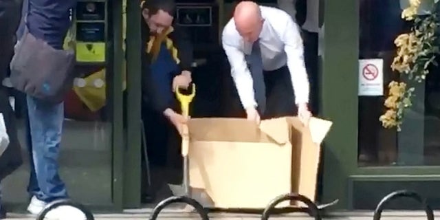 Two employees were filmed using cardboard and a shovel to chase the rat out.