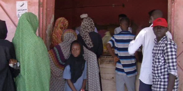 In this frame grab from video, people wait in line for bread outside a bakery in Khartoum, Sudan, Sunday, June 9, 2019. The first day of the workweek in Sudan saw shops closed and streets empty as part of a general strike called by protest leaders who are demanding the resignation of the ruling military council. The Sudanese Professionals Association had urged people to stay home to protest a deadly crackdown last week, when security forces violently dispersed the group’s main sit-in camp outside the military headquarters in the capital of Khartoum. (AP Photo)