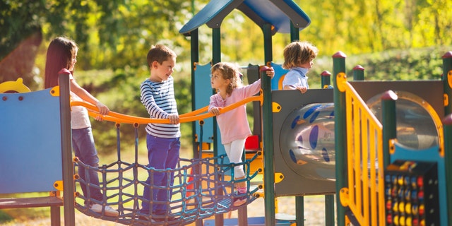 If you are age 14 or over, you may not play on a playground in Kansas. Parents and caregivers are excluded from this rule, according to Kansas law.