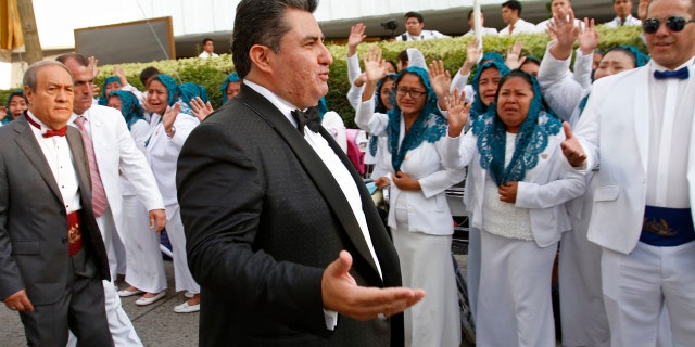 In this Aug. 14, 2018 photo, Joaquín García, 50, greets members of his church "La Luz del Mundo" in Guadalajara, Mexico.(AP Photo)