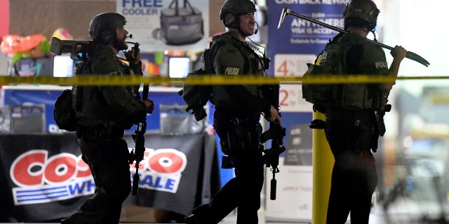 Heavily armed police officers leave Costco following a shootout in the wholesale warehouse in Corona, California on Friday, June 14, 2019.