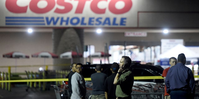A Costco employee talks on the phone following a shooting within the wholesale outlet in Corona, Calif., Friday, June 14, 2019.