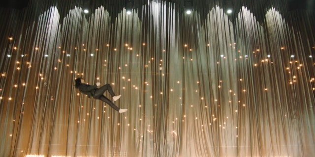 Criss Angel performs his signature levitation illusion.