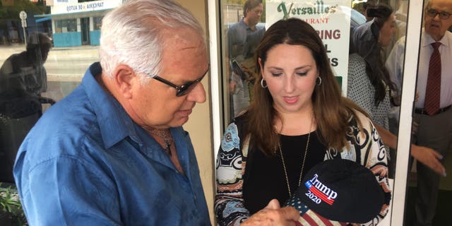 Emilio Izquierdo, a 71-year-old Cuban-American exile, gives his hat to Republican National Committee chairman Ronna McDaniel in Little Havana. (Alex Pappas/Fox News).