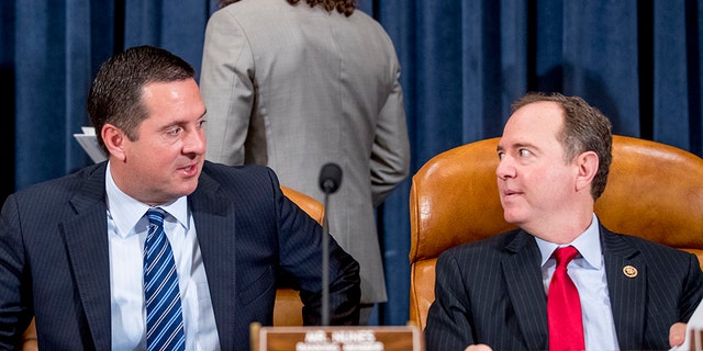 Chairman Rep. Adam Schiff, D-Calif., right, speaks with Ranking Member Rep. Devin Nunes, R-Calif., left, before a House Intelligence Committee hearing on national security implications of climate change on Capitol Hill in Washington, Wednesday, June 5, 2019. (AP Photo/Andrew Harnik)