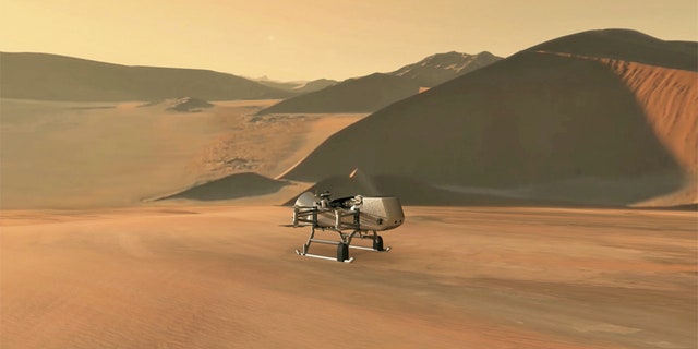 This illustration shows NASA’s Dragonfly rotorcraft-lander approaching a site on Saturn’s exotic moon, Titan. Taking advantage of Titan’s dense atmosphere and low gravity, Dragonfly will explore dozens of locations across the icy world, sampling and measuring the compositions of Titan's organic surface materials to characterize the habitability of Titan’s environment and investigate the progression of prebiotic chemistry. Credits: NASA/JHU-APL