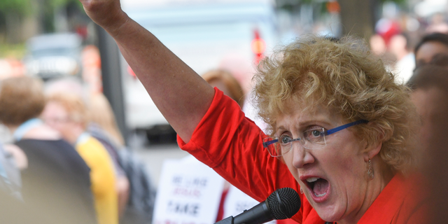 Christa Brown, of Denver, Colo., speaks outside the Southern Baptist Convention's annual meeting Tuesday, June 11, 2019, during a rally in Birmingham, Ala. (AP Photo/Julie Bennett)