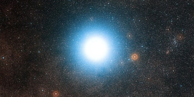 A new planet-hunting instrument has begun studying our bright neighboring star system, Alpha Centauri. Credit: ESO/Digitized Sky Survey 2 Acknowledgement: Davide De Martin