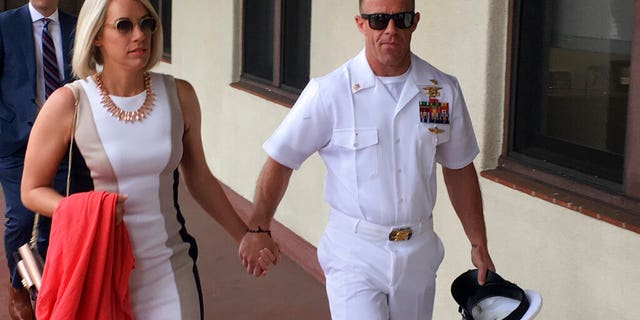 Navy Special Operations Chief Edward Gallagher, right, walks with his wife, Andrea Gallagher as they arrive to military court on Naval Base San Diego. (AP Photo/Julie Watson)