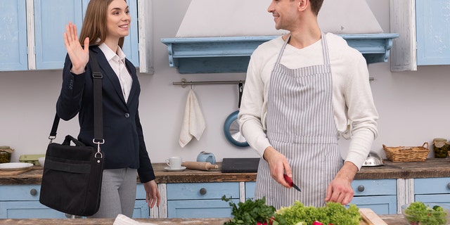 Happy confident woman going to work and her husband cooking dinner.
