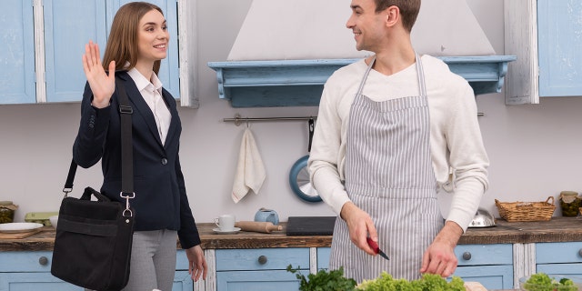 Happy confident woman going to work and her husband cooking dinner.