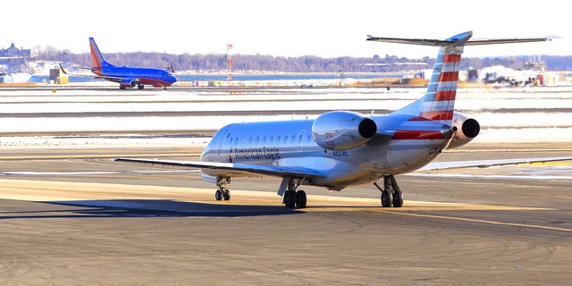  American Airlines Embraer ERJ-140 waiting for take-off from Boston Logan International Airport after snow. (iStock)