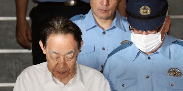Hideaki Kumazawa, left, a former top Japanese government official,has been arrested in his son's killing and media reports say the retired bureaucrat told investigators he had feared his reclusive son might harm others.