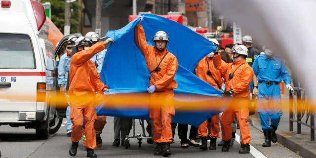 In this May 28, 2019, file photo, rescuers work at the scene of an attack in Kawasaki, near Tokyo Tuesday, May 28, 2019.