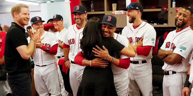 Meghan, Duchess of Sussex embraces Boston Red Sox player Mookie Betts. 
