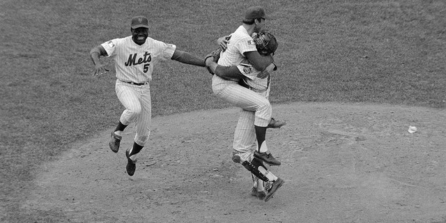 Met third baseman Ed Charles jumps with joy as pitcher Jerry Koosman and catcher Jerry Grote hug each other after the New York Mets downed the Baltimore Orioles, 5-3, in the fifth game of the World Series, Oct. 16, to take the championship title.