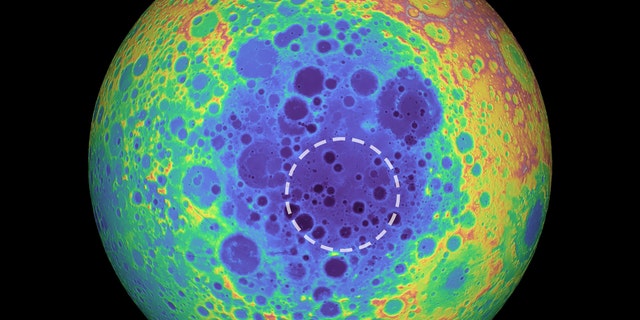 This false-color graphic shows the topography of the far side of the Moon. The warmer colors indicate high topography and the bluer colors indicate low topography. The South Pole-Aitken (SPA) basin is shown by the shades of blue. The dashed circle shows the location of the mass anomaly under the basin. (Credit: NASA/Goddard Space Flight Center/University of Arizona)
