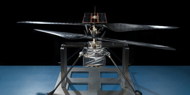 This image of the flight model of NASA's Mars Helicopter was taken on Feb. 14, 2019, in a cleanroom at NASA's Jet Propulsion Laboratory in Pasadena, California. The aluminum base plate, side posts, and crossbeam around the helicopter protect the helicopter's landing legs and the attachment points that will hold it to the belly of the Mars 2020 rover. (Credit: NASA/JPL-Caltech )