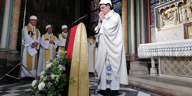 The Archbishop of Paris Michel Aupetit leads the first mass in a side chapel two months to the day after a devastating fire engulfed the Notre-Dame de Paris cathedral, in Paris, France