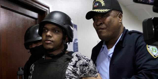 José Eduardo Ciprian, a suspect in connection with the shooting of former Boston Red Sox slugger David Ortiz, is taken to court by police in Santo Domingo, Dominican Republic, Friday, June 14, 2019. Ortiz was shot in the back at a bar in the Dominican Republic on Sunday, June 9. (AP Photo/Roberto Guzman)