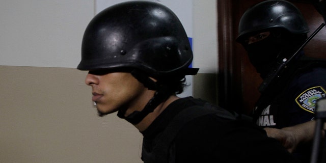 Rolfy Ferreyra Cruz, a suspect in connection with the shooting of former Boston Red Sox slugger David Ortiz, is taken to court by police in Santo Domingo, Dominican Republic, Friday, June 14, 2019. Ortiz was shot in the back at a bar in the Dominican Republic on Sunday, June 9. (AP Photo/Roberto Guzman)