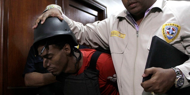 Joel Rodríguez Cruz, a suspect in connection with the shooting of former Boston Red Sox slugger David Ortiz, is taken to court by police in Santo Domingo, Dominican Republic, Friday, June 14, 2019. Ortiz was shot in the back at a bar in the Dominican Republic on Sunday, June 9. (AP Photo/Roberto Guzman)