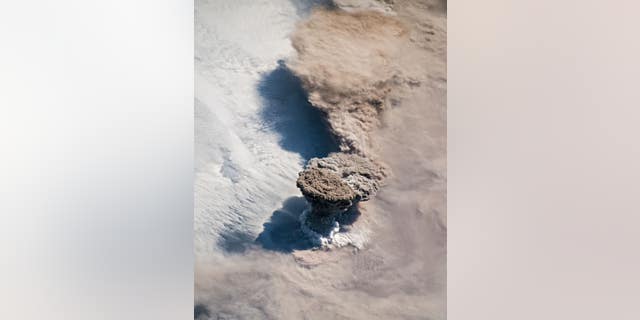 This NASA Earth Observatory image by Joshua Stevens shows the eruption of the Raikoke volcano.