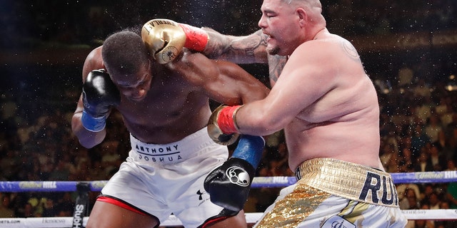 Andy Ruiz, right, punches Anthony Joshua during the seventh round of a heavyweight championship boxing match. (AP)