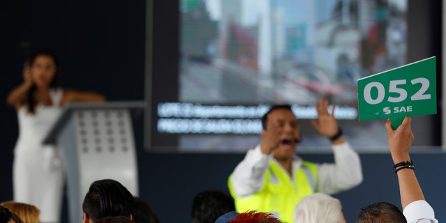 A man bids during an auction of seized properties from drug traffickers and others, in Mexico City, Mexico June 23, 2019.
