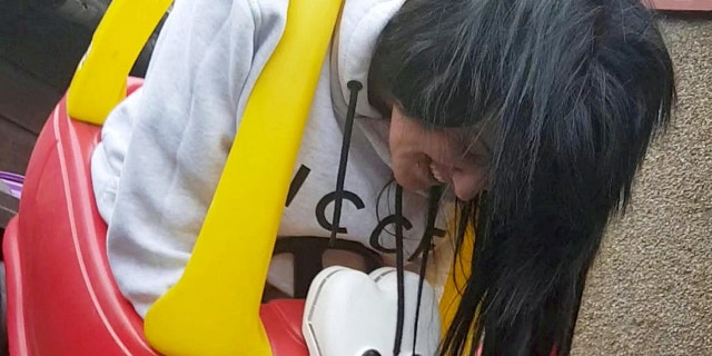 This is the hilarious moment a woman has to be cut free from a toddler's toy car using a bread knife.
