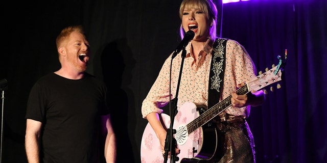 Jesse Tyler Ferguson (L) and Taylor Swift perform at AEG and Stonewall Inns pride celebration commemorating the 50th anniversary of the Stonewall Uprising.