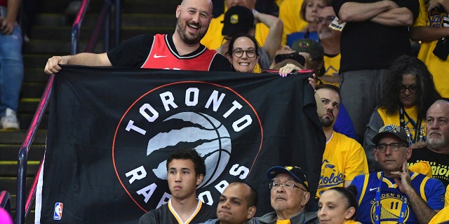 Toronto Raptors fans smile during the second half of the team's Game 4 of basketball’s NBA Finals against the Golden State Warriors, Friday, June 7, 2019, in Oakland, Calif. (Associated Press)