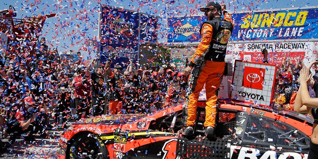 Martin Truex Jr. celebrates after winning a NASCAR Sprint Cup Series auto race Sunday, June 23, 2019, in Sonoma, Calif. (AP Photo/Ben Margot)