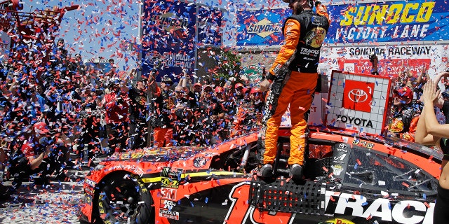 Martin Truex Jr. celebrates after winning a NASCAR Sprint Cup Series auto race Sunday, June 23, 2019, in Sonoma, Calif. (AP Photo/Ben Margot)