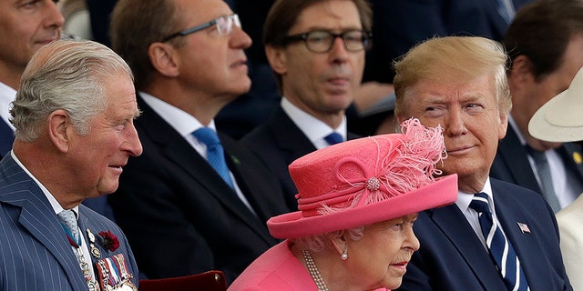 Britain's Queen Elizabeth II, sits in-between President Donald Trump and Prince Charles as they attend an event to mark the 75th anniversary of D-Day in Portsmouth, England Wednesday, June 5, 2019. 