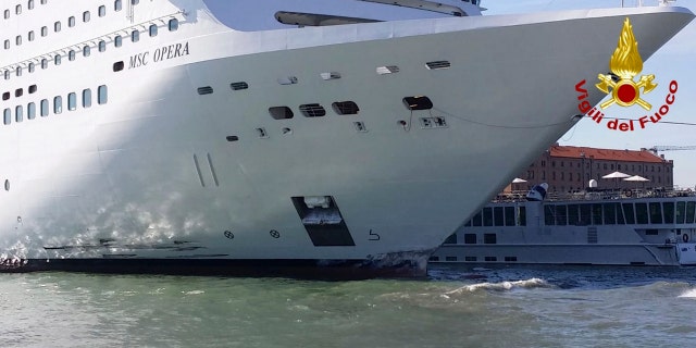 The MSC Opera cruise liner stand by a tourist boat following a collision in Venice, Italy, Sunday, June 2, 2019.