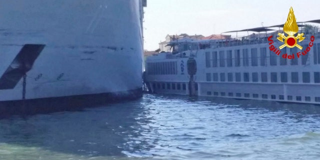 The MSC Opera cruise liner stand by a tourist boat following a collision in Venice, Italy, Sunday, June 2, 2019.