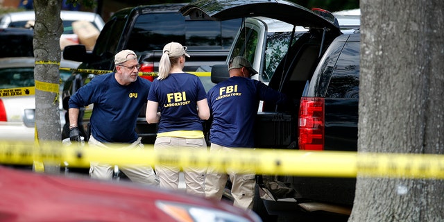 Police said the investigation is ongoing for a possible motive for the deadly rampage that killed 12 people and left several others injured Friday. (AP)