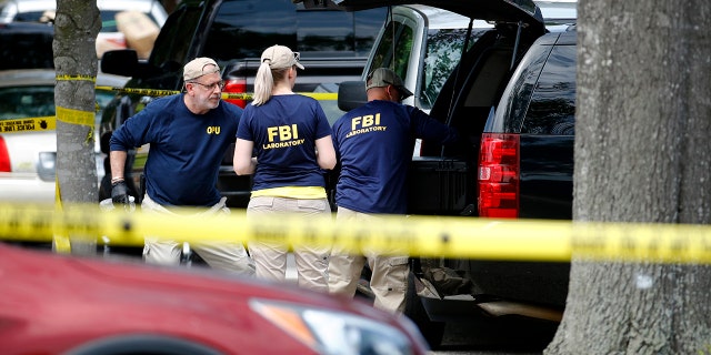 Police said the investigation is ongoing for a possible motive for the deadly rampage that killed 12 people and left several others injured Friday. (AP)