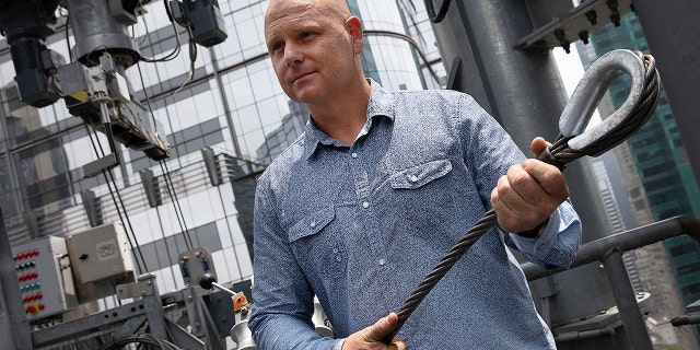 Aerialist Nik Wallenda talks with the media about his planned high-wire act, Thursday, June 20, 2019 in New York. Wallenda and his sister Lijana will cross Times Square on a high wire on Sunday. He is holding a cable similar to the one that will stretch across the square.