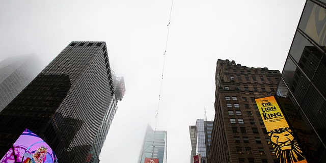 A high-wire crosses Times Square, Thursday, June 20, 2019 in New York. Performers Nik and Lijana Wallenda will cross Times Square on the high wire on Sunday.