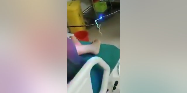 This is the moment a woman who has been suffering from stomach pains for a decade has a foot-long parasitic worm pulled out of her intestines.