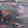 Protesters are hit by a blast from a police water cannon during a demonstration against a proposed extradition bill in Hong Kong, China, June 12, 2019. 