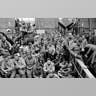 American servicemen huddle on D-Day war ship.