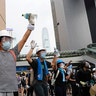 Demonstrators stand up to police near the Legislative Council in Hong Kong, June 12, 2019. 