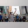 Demonstrators stand up to police near the Legislative Council in Hong Kong, June 12, 2019. 