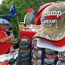 People looking over merchandise on sale outside the arena.