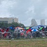 President Trump supporters standing in line in the rain as they wait to enter the Amway Center in Orlando on Tuesday.