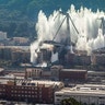 A cloud of dust rises as the remaining spans of the Morandi bridge are demolished in a planned explosion, in Genoa, Italy, June 28, 2019. 