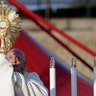 Pope Francis holds up a monstrance containing a Holy Host as he presides over a ceremony for the Feast of Corpus Christi, in Rome's Casal Bertone neighborhood, June 23, 2019. 